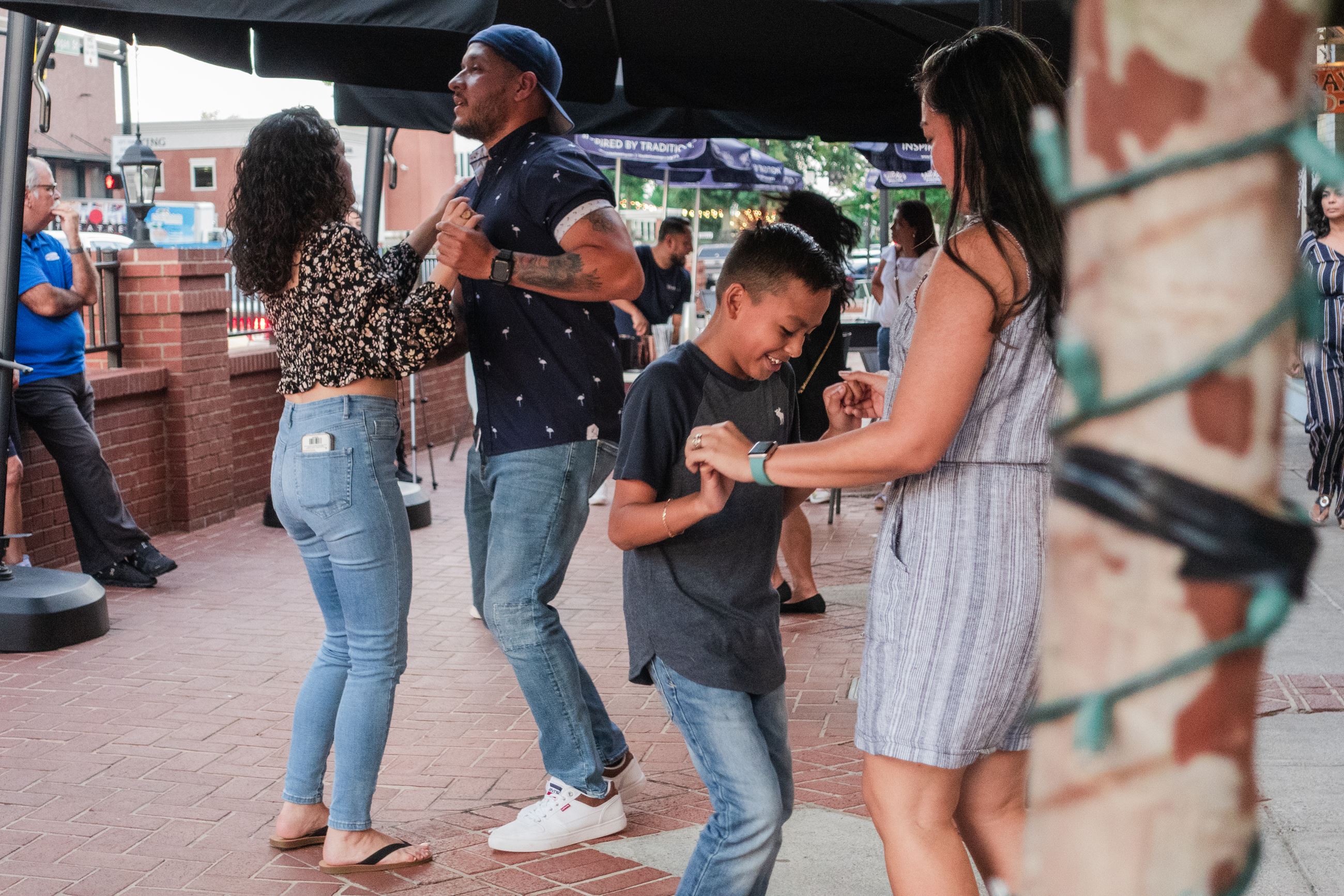 People salsa dancing on the sidewalk